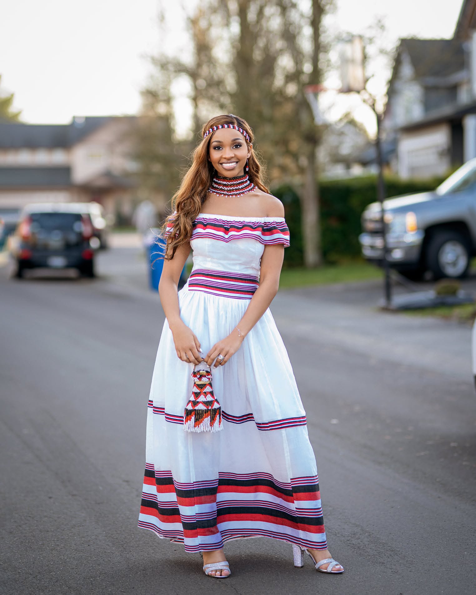 Portrait in traditional striped dress and beadwork