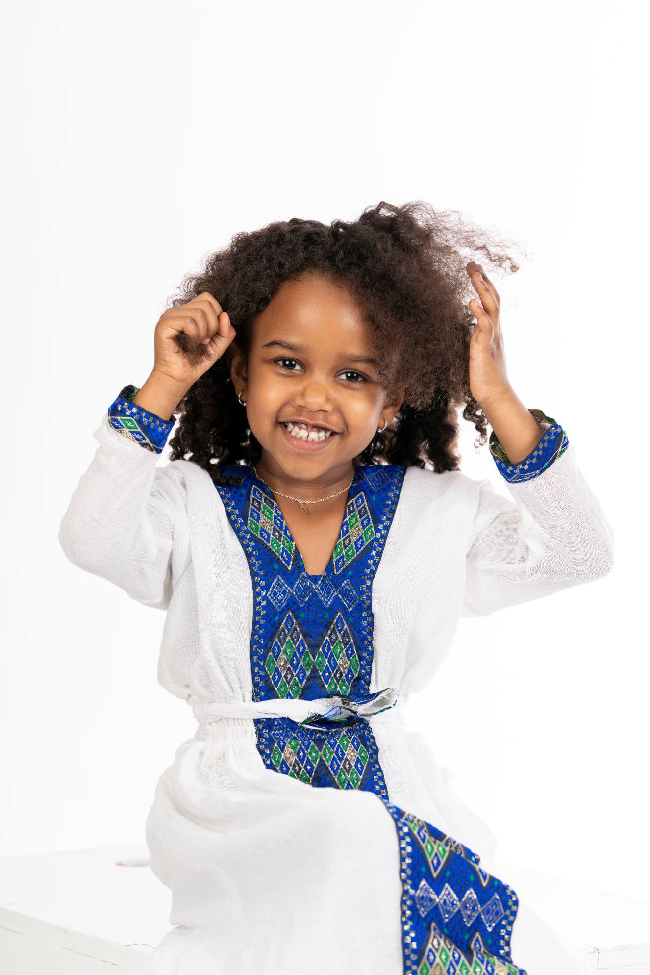 Young girl in a white and blue traditional dress