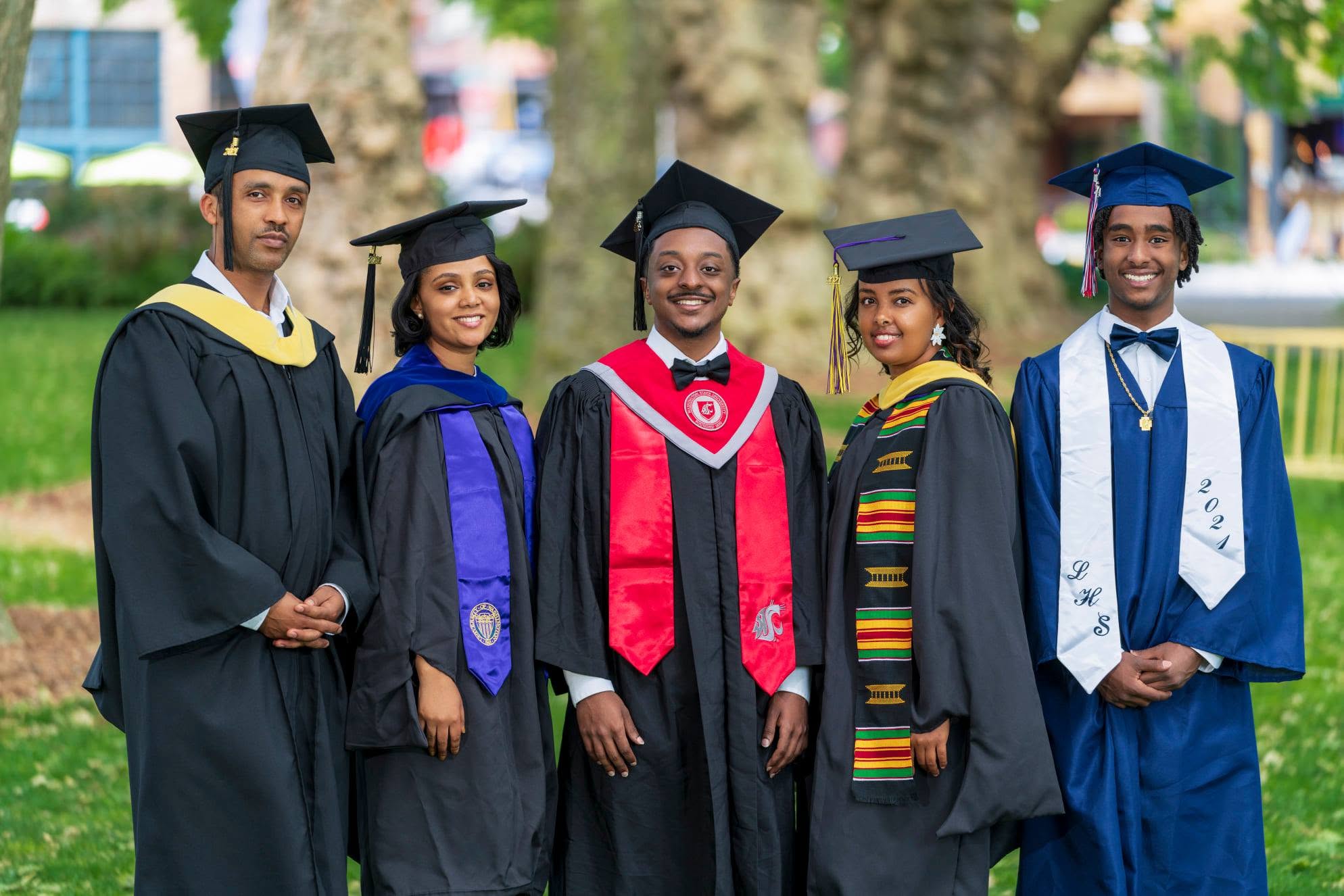 Group of graduates in caps and gowns outdoors