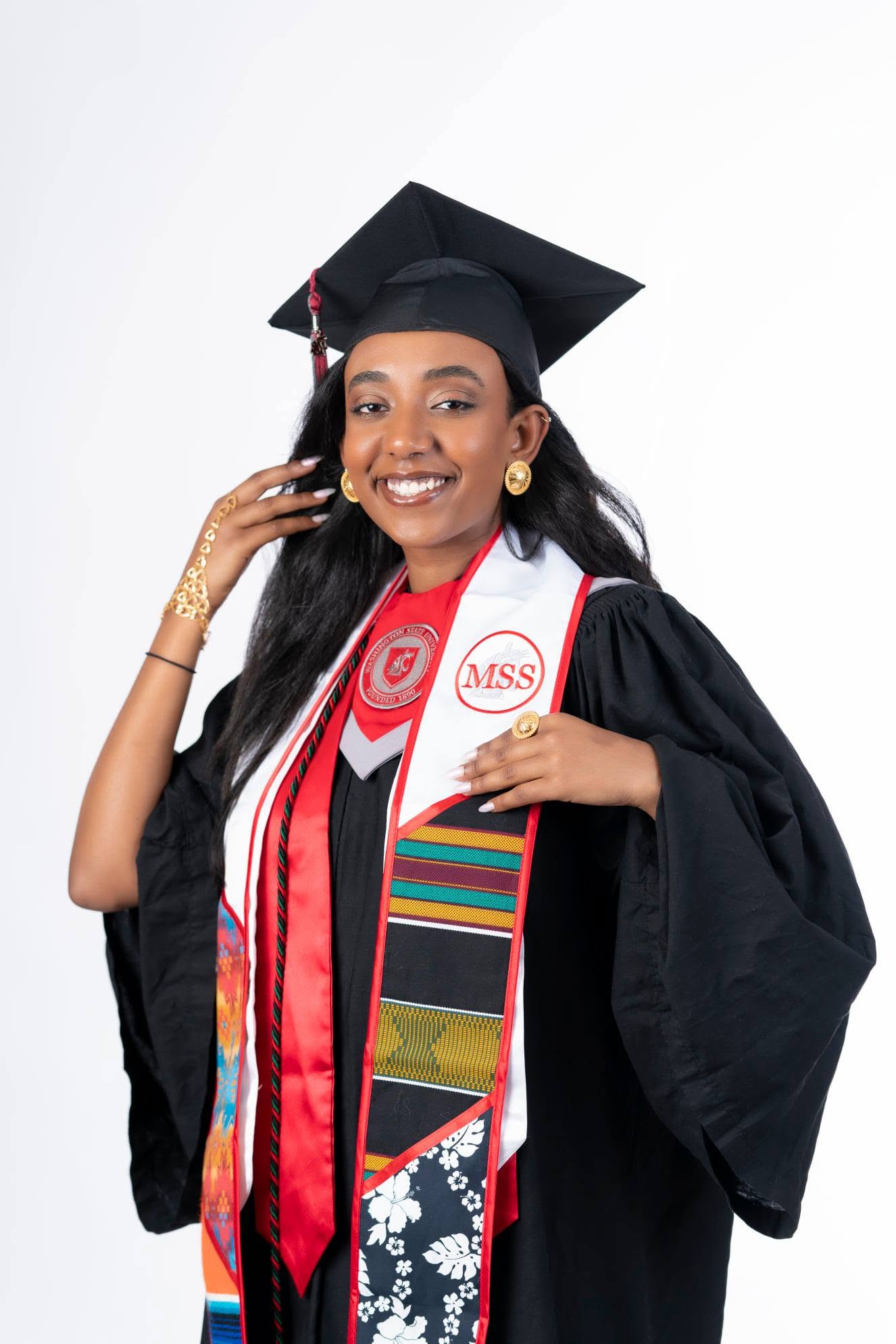 Graduate in cap, gown and cultural stoles
