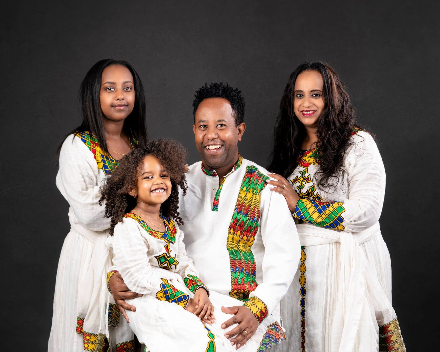 Family of four in matching traditional habesha dress