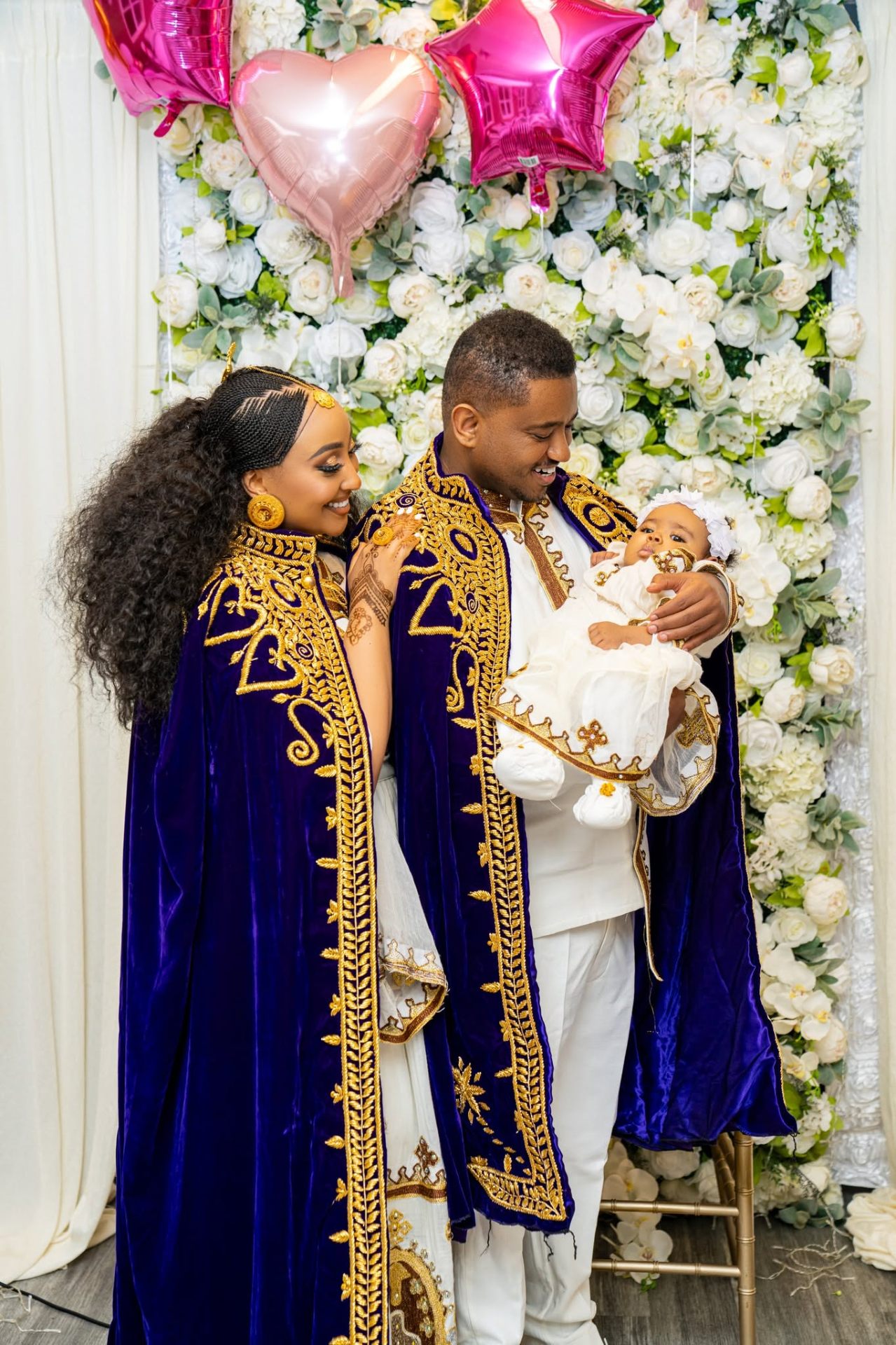 Family in royal capes celebrating a christening